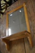 A Victorian hall mirror with shelf under