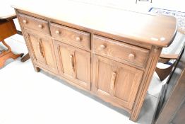 An Ercol sideboard/dresser base, medium/dark stained