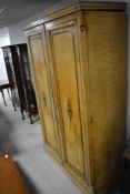 A Victorian scumbled double Gentlemans wardrobe, with rail and drawer sections , having Aesthetic