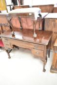 An early 20th Century mahogany dressing table and similar tapestry seated footstool