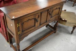 A reproduction oak side cabinet/small dresser base in the Titchmarsh and Goodwin style, width