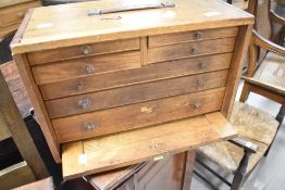 A vintage wooden portable specimen or parts cabinet