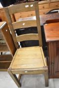 A traditional ladderback kitchen chair having solid seat