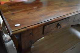 A modern hardwood console table having triple frieze drawers and shaped legs, width approx. 140cm,