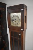 A 1930s oak long cased clock having silvered dial with Arabic numerals , height approx. 184cm
