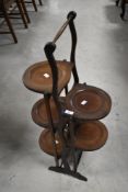 An Edwardian mahogany folding cake stand