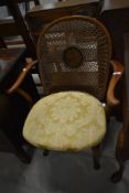 A traditional carver chair having bergere style cane seat and back