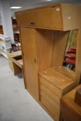 A mid Century golden oak bedroom unit in the Gomme G Plan style having sliding door wardrobe with