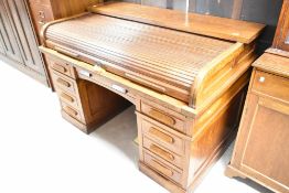 A late 19th or early 20th Century Globe Wernicke oak roll top desk having tambour top