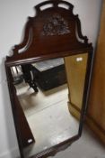 Am early 20th Century mahogany framed wall mirror, having applique decoration, approx. 117 x 54cm