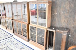 A run of early 20th Century oak bookcases, three double (width approx 81cm) and one triple (width