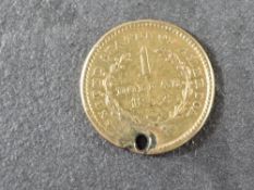 A 1852 US Gold One Dollar, holed, 1.5g