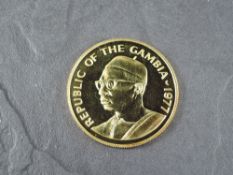 A 1977 Gambia 500 Dalasis Gold Coin, Sitatunga to reverse, Uncirculated in plastic capsule and
