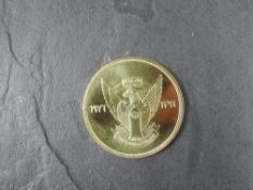A 1976 Sudan 100 Pounds Gold Coin, Antelope to reverse, Uncirculated in plastic capsule and in Royal