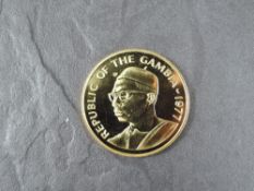 A 1977 Gambia 500 Dalasis Gold Coin, Sitatunga to reverse, Uncirculated in plastic capsule and
