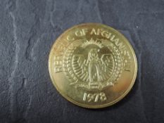 A 1978 Afghanistan 10000 Afghanis Gold Coin, Marco Polo Sheep to reverse, Uncirculated in plastic