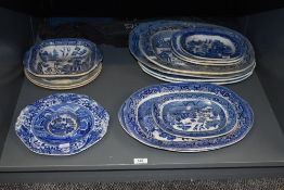 A large selection of blue and white Willow pattern platters and plates, to include a small round