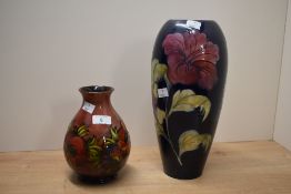 A Moorcroft pottery 'Big Poppy' baluster vase having a washed redground, signed to base, h18cm, sold