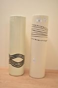 A pair of cylindrical ceramic vases, decorated having tribal patterns on a cream ground, h43cm