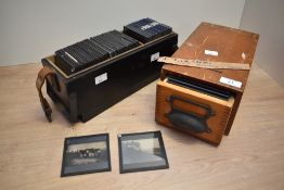 Two early 20th century vintage optician boxes containing various glass slides, manufactured by J.