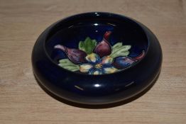 A small Moorcroft pottery Columbine pattern bowl, having inverted rim and central floral
