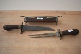 A vintage Indian wood and brass meat carving knife, decorated having intricate foliage patterns with