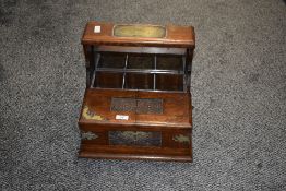 An early 20th century oak Tantalus, having carved decoration and plated mounts, w35cm. Condition