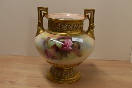 A Royal Worcester two-handled vase, the everted gilt rim above a shallow neck pierced with anthemion