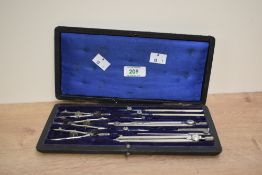 An early 20th century Cartographer's / drawing instrument set, having 11 pieces within a rich blue