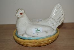 A 19th century white ceramic Staffordshire style Hen on yellow nest, W19cm x H15cm