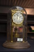 An early 20th century German 400 day anniversary clock, under glass dome with torsion pendulum,