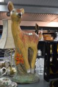 A heavy cast composite stone fawn baby deer sculpture in the Walt Disney style, hand coloured with