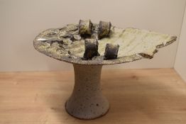 An unusual studio pottery stoneware sculpture having impressed Aztec patterns to top, supported on a