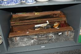 A large vintage black painted wooden carpenters tool box, having leather handle, inside containing a