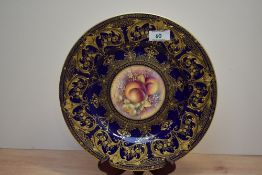An attractive Royal Worcester fine bone China plate, hand painted with peaches and grape's