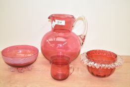 A late 19th / early 20th century hand blown glass pitcher, blown is a particularly rich cranberry