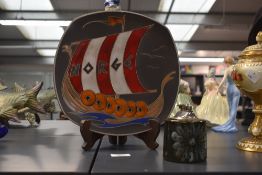 An attractive mid-century wall plate depicting a Norwegian Viking ship decorated in red, blue and