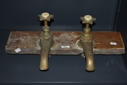 Large 19th century reclaimed brass bath taps, the taps having a ceramic top signed Calveht &
