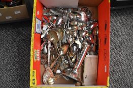 A box containing various silver plated cutlery, to include a candle stick, a large soup spoon, a