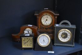 An early 20th century mantel clock having brass dial with Roman numerals, housed in an oak case,