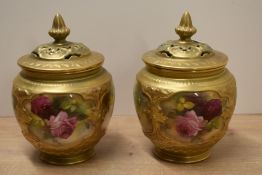 A pair of Royal Worcester porcelain pot pourri vases and covers, the bulbous bodies with gilt