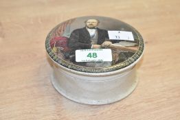 A 19th century circular pratt ware pot, decorated having a transfer print of a seated gentleman,