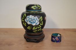 A Chinese Cloisonné enamel lidded ginger jar having floral pattern of a black ground, h14cm, sold
