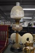 A late 19th / early 20th century brass and glass oil lamp, decorated having fluted column and