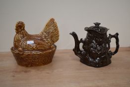 A vintage Toby style tea pot decorated with seated figure on a brown glaze ground, h18cm, sold