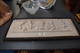 A cast composite relief panel in the neo-classical style depicting dancing fauns at play, marked