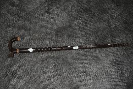 A late 19th / early 20th century bobbin style walking stick, carved from dark Afromosa wood, L85cm