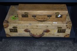 An early 20th century vellum suitcase with leather handle and brass fixtures, initiala 'I.A.C' to
