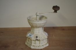 A vintage Kenrick cast iron coffee grinder in the form of a mill, having wooden handle and impressed