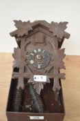 A vintage German black forest style cuckoo clock, having carved leaf and pine decoration, H20cm, A/